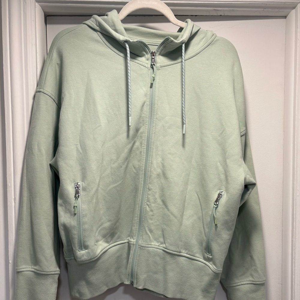 Sage Green Zip-Up Hoodie   Size Large
2 Zippered pockets